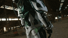 a person in a green and white costume is standing in a warehouse