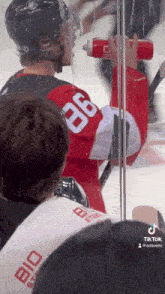 a hockey player wearing a red jersey with the number 36 on it