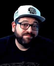 a man with a beard and glasses is wearing a white hat