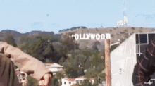 a hollywood sign is visible in the distance behind a building
