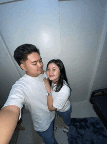 a man and a woman pose for a selfie together