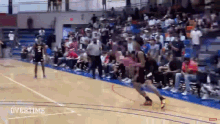 a basketball game is being played in front of a crowd of people