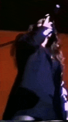 a person wearing a black jacket with the letter c on it