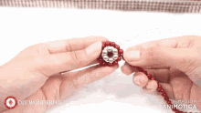 a person is making a necklace with red beads and silver beads and the words diy wonderful are on the bottom