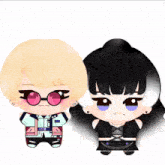 a couple of stuffed dolls one of which has a jacket that says coco