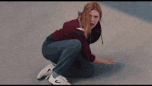 a woman is squatting on the ground wearing white nike shoes