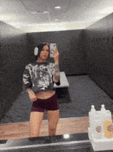 a woman takes a selfie in a locker room