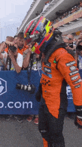 a man wearing a monster helmet is standing in front of a crowd