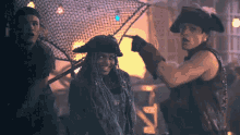 a man in a pirate hat is pointing at a woman in a pirate costume