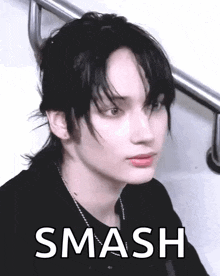 a close up of a person 's face with the words `` smash '' written in white .