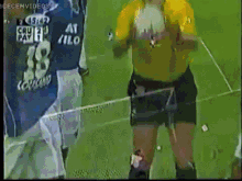 a soccer player wearing a number 18 jersey stands on the field