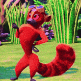 a red cartoon animal wearing a hat and goggles is standing in the grass