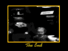 a picture of a man holding a baby with the words the end in yellow letters