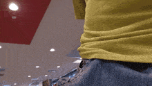 a person in a yellow shirt is holding a piece of paper
