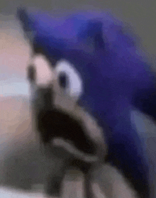 a close up of a sonic the hedgehog with his mouth open and a surprised look on his face .