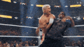 two men are wrestling in a boxing ring with a crowd watching