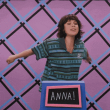a woman stands behind a podium that says anna on it