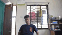 a man standing in front of a window with a calendar on the wall