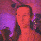 a woman 's face is visible in a pixelated image with a red background