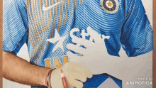 a man is wearing a blue shirt with the word star on the front