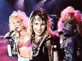 a man and two women are singing into microphones