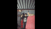 a young boy is standing under a bunk bed .
