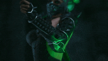 a person in a green and black costume with spikes