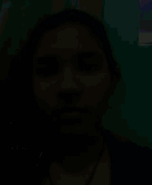 a close up of a girl 's face with a necklace around her neck