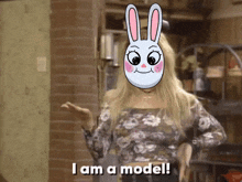 a woman wearing a rabbit mask says i am a model