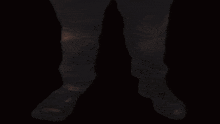 a close up of a man 's face with a mustache in a dark room .