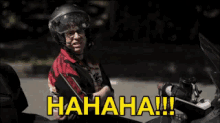a man wearing a helmet is laughing while sitting on a motorcycle with the words " hahaha !!! " on the bottom