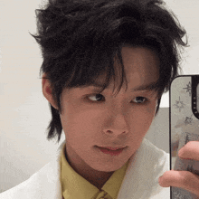 a man is taking a picture of himself in a mirror with a case that says casetify on it