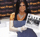 a woman is holding a bliss magazine