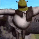 shrek is standing on a cross with his arms outstretched in front of a truck .