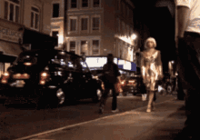 a woman walks down a street at night in front of a sign that says ' celica ' on it