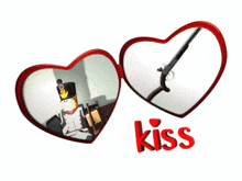 a heart shaped mirror with the word kiss on the bottom