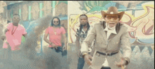 a man in a cowboy hat is standing in front of a group of men .