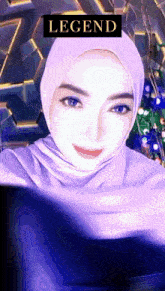 a woman wearing a purple hijab has a legend sticker on her head