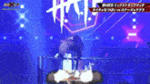 a wrestling match is being shown in a foreign language on a television screen