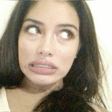 a close up of a woman making a face