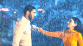 a man and a woman are standing in the rain and the word hd is on the bottom left