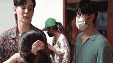 a man with a mask on his face is standing next to a woman