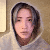 a woman with blue hair is wearing a hoodie