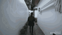 a man in a black jacket is walking down a narrow alleyway made in animatica