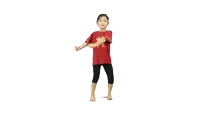 a little girl wearing a red shirt with a dragon on it is dancing