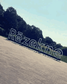 a sign that says rezekne is on a brick walkway