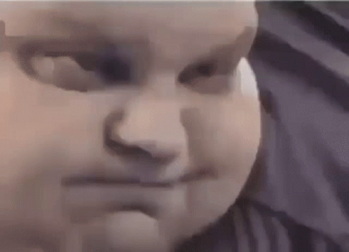 a close up of a baby 's face with a purple background .