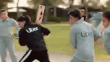 a group of cricket players are playing a game of cricket on a field .