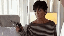 Kris Jenner Holding A Gun GIF - Kris Jenner Holding A Gun GIFs