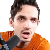 a man with a mustache is talking into a microphone